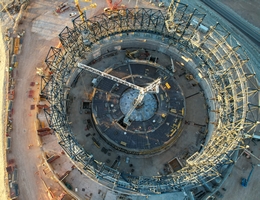 Dieses Bild, aufgenommen Ende Juni 2023, zeigt eine Drohnenaufnahme der Baustelle des Extremely Large Telescope der ESO auf dem Cerro Armazones in der chilenischen Atacama-Wüste. Dort sind Ingenieurinnen und Ingenieure, Handwerkerinnen und Handwerker gerade dabei, die Struktur der Teleskopkuppel in einem rasanten Tempo zu montieren. Die Stahlkonstruktion, die sich jeden Tag sichtbar verändert, wird bald die für Teleskopkuppeln typische runde Form annehmen. Die Basis der Teleskopstruktur ist in der Mitte des Rahmens sichtbar. (Bild: ESO)